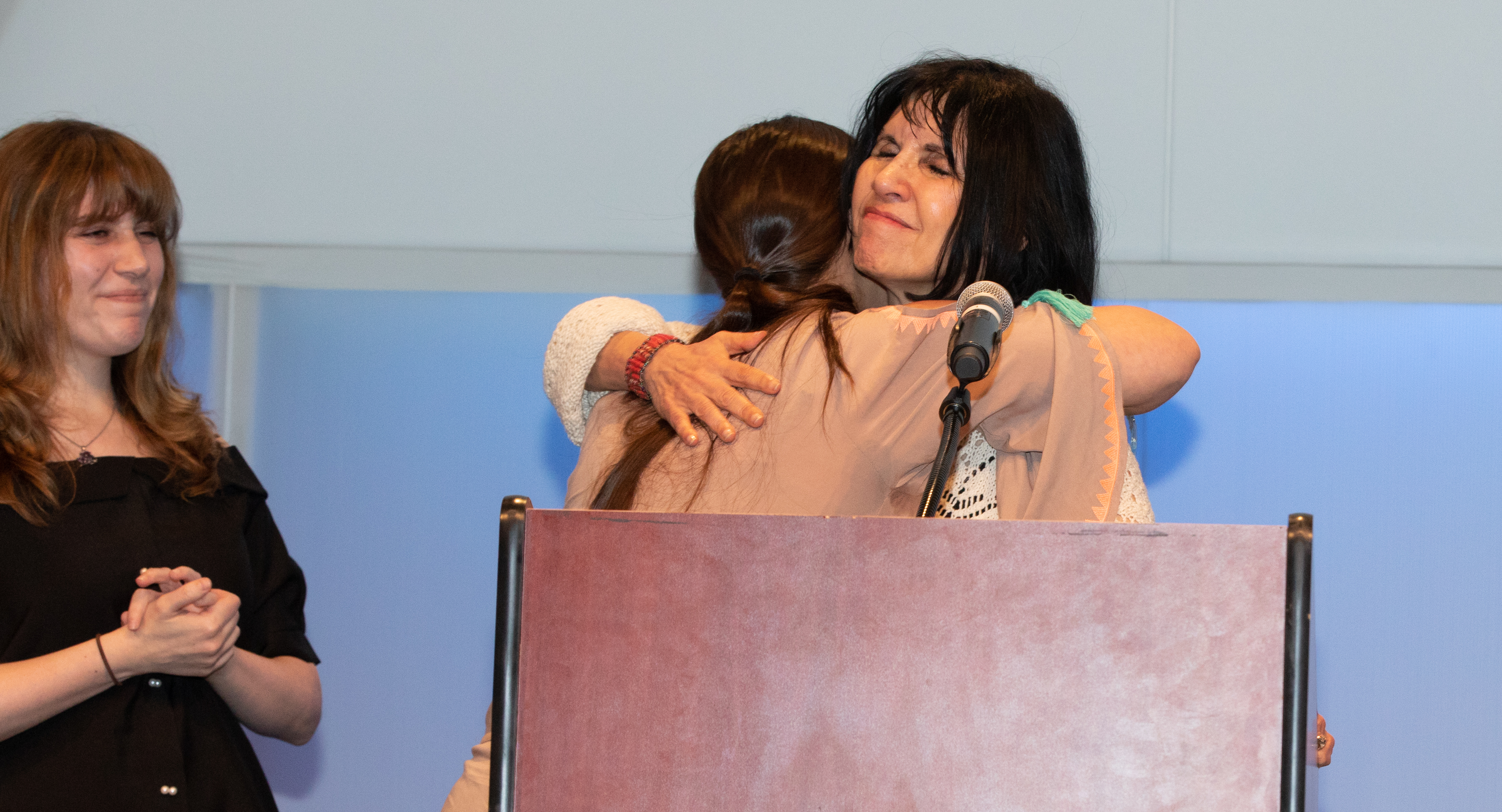 Dr. Kathy Giacomini hugs Naomi Evans as she presents her the first annual Mary Frances McMahon Outstanding Clinician Award.