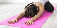 A person doing yoga. Exercise is a self-care recommendation.
