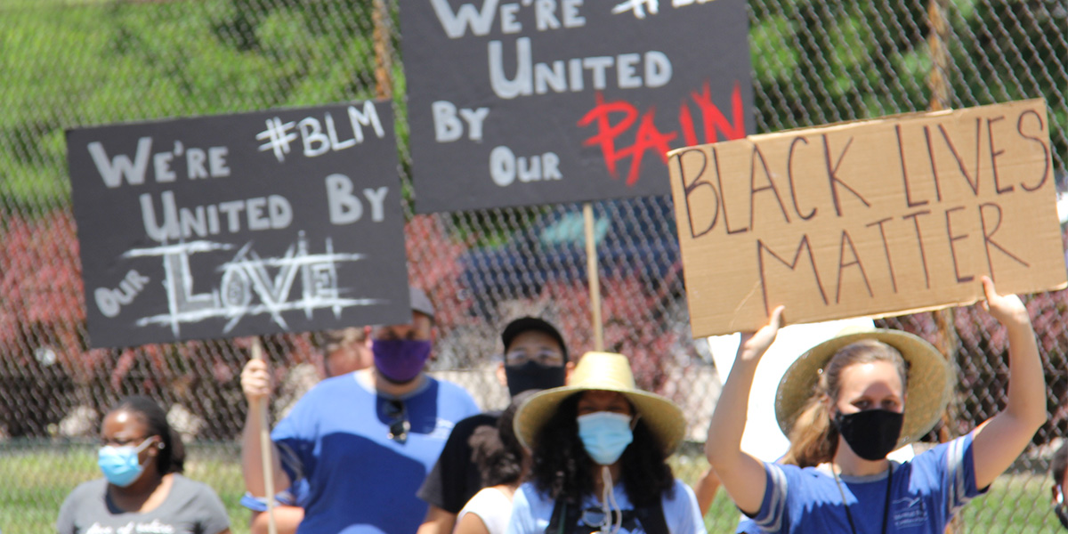 Employees march in support of ending anti-Black racism.