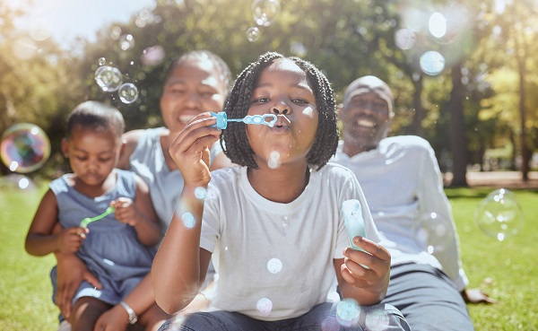 Happy,,Nature,And,Black,Family,Blowing,Bubbles,While,Playing,,Bonding