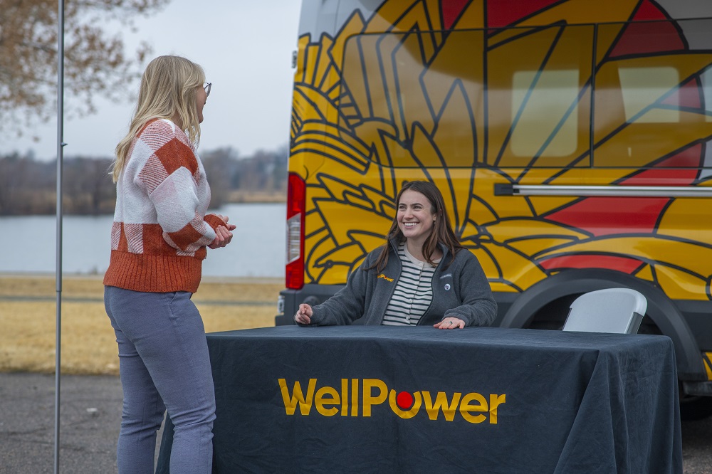WellPower staff  Amanda (left) and Maeve (right) set up the Road to Well-Being Van