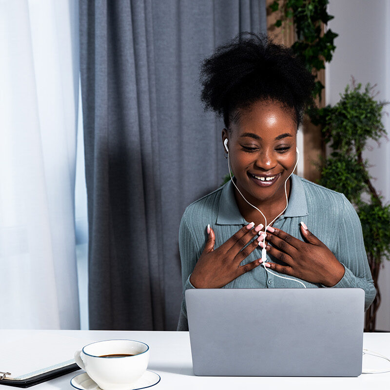 2512_STOCK_Telehealth Header_Black woman talking on computer with headphones