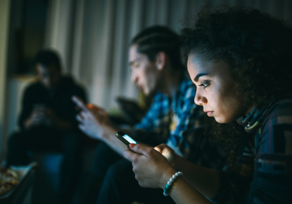 2603_STOCK_Young adults on phones_Loneliness epidemic