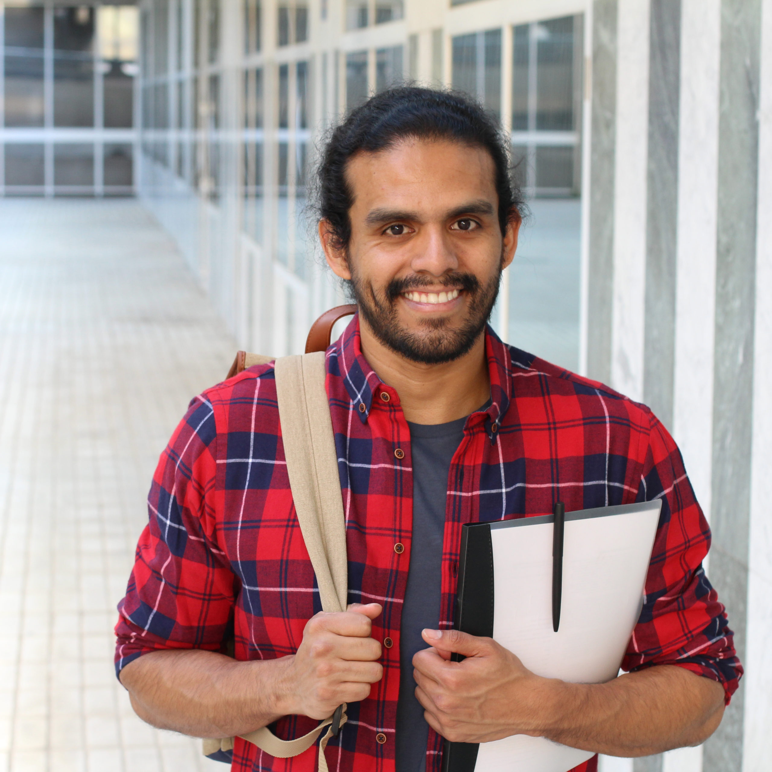 College student with backpack and books posing on campus - Stock image with copy space.