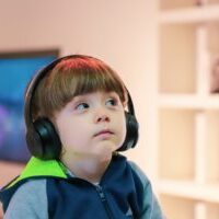 little boy wearing headphones