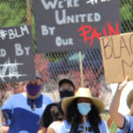 Employees march in support of ending anti-Black racism.