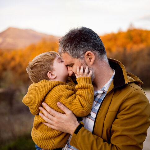 Father and son enjoying a carefree autumn day in nature.