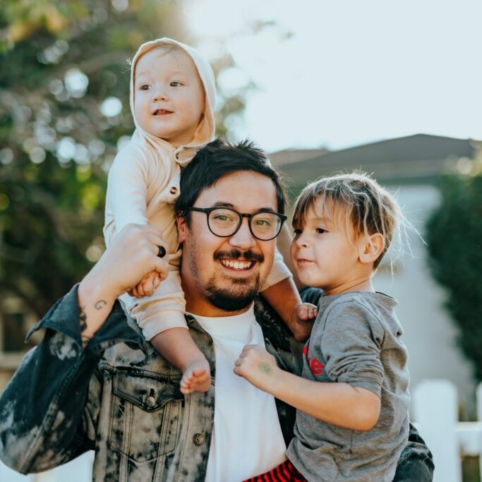 Dad with two kids smiling